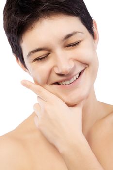 girl with a short hair smiling and touching her face