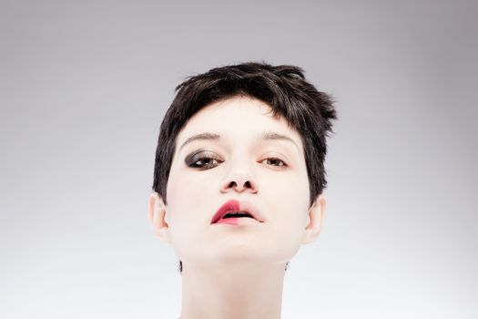 girl with a short hair, having half her face with make up