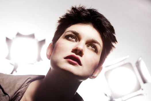 studio portrait of a girl with short hair, looking up