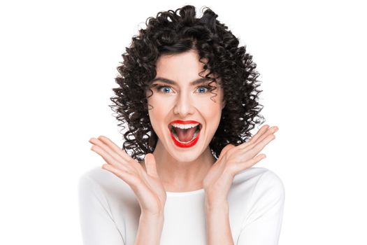 Surprised excited beautiful woman screaming amazed in joy, isolated on white background