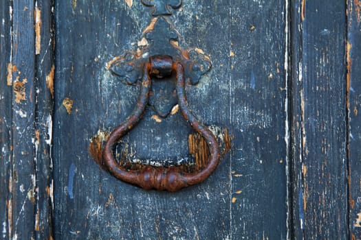 Brass  knocker on old wooden door in Lisbon