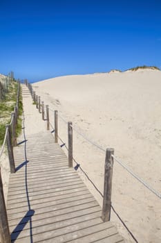 Wooden board path way to the sandy beach