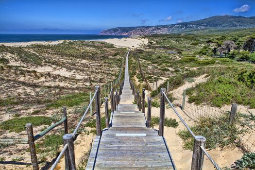 Wooden board path way to the sandy beach