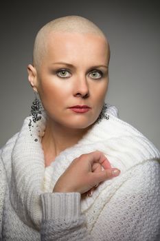 Portrait of beautiful middle age woman patient with cancer with shaved head without hair, hope in healing. She lost her hair