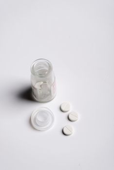 Pills and medicine over a white board