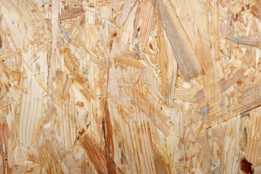 Dark and light wooden strips in flakeboard sheet building material. Abstract construction background.