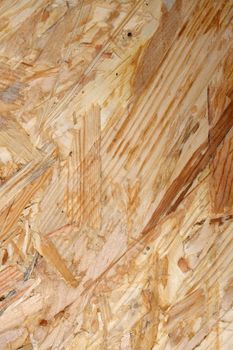 Wood grain stripes in abstract background of OSB or flakeboard - wooden sheet material for construction.