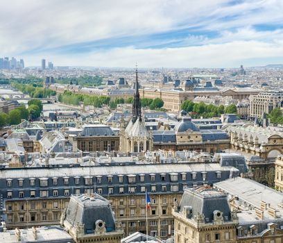 Top view of northwestern part of Paris from the tower of the Cathedral Notre-Dame de Paris with Police prefecture and Sainte-Chapelle in the foreground against of a sky in the springtime
