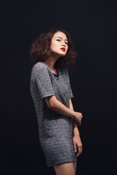 Attractive young asian woman in a black dress. Stylish girl model.