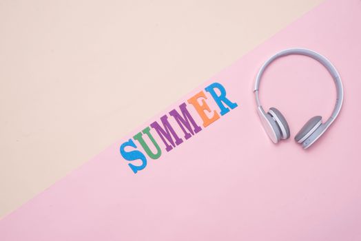 Summer fun written in colorful wooden letters on pastel color background.