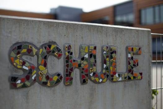 German school sign on a wall of concrete