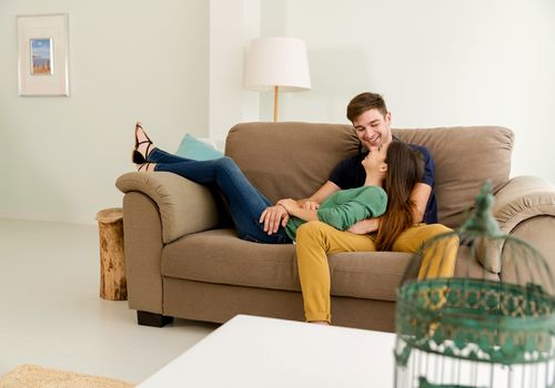 Young couple sitting on the sofa and dating