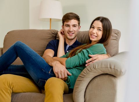 Young couple sitting on the sofa and dating