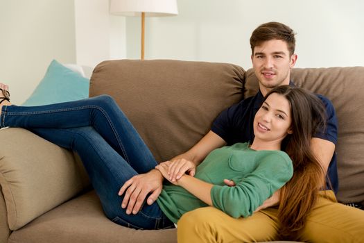 Young couple sitting on the sofa and dating