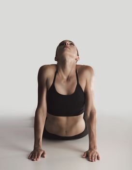Shot of a young woman doing stretching exercises 