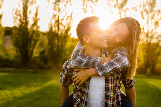 Portrait of a happy young couple in the nature hugged together