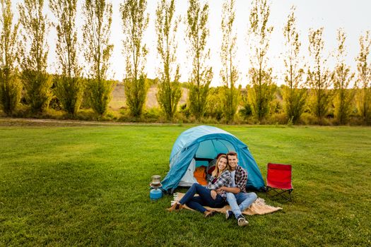 Shot of a happy couple camping on the nature 