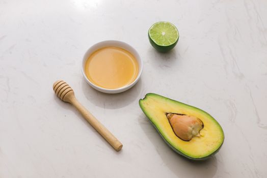 Healthy food concept. Fresh organic avocado with honey on table