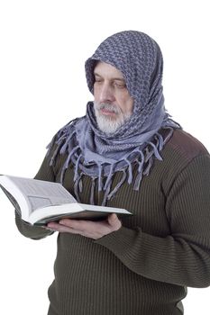 Muslim man with a Quran in hands on a white background
