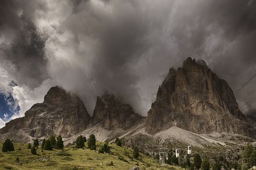 Thunderstorm formation over the top of Sassolungo seen from Sella Pass in a summer afternoon of august