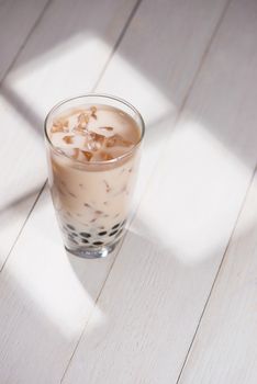 Boba / Bubble tea. Homemade Taro Milk Tea with Pearls on wooden table.