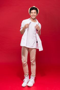 Full length of elegant young handsome asian man with hat. Cool fashion male model.