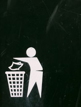 a black and white bin sign with texture scratches and dents and marks and fade, interesting symbol of person putting rubbish into a bin to keep the place clean and safe outside