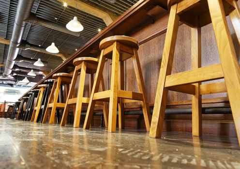 wooden bar stools in a row