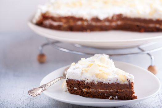 A slice of carrot cake, gluten-free, flour from rice, flax. Selective focus.