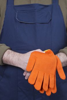 Man in working clothes with gloves. Isolated on a white background.
