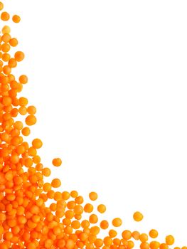 Red orange lentil Football type with copy space. Isolated one edge. Top view or flat lay. Vertical.