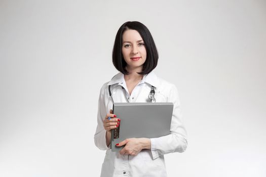 the young beautiful woman the doctor on a white background