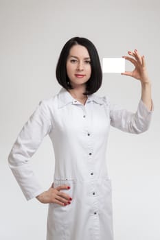 the young beautiful woman the doctor on a white background