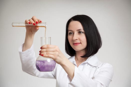 the beautiful woman the doctor with beakers on a white background