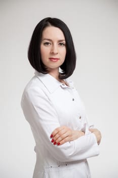 the beautiful woman the doctor in a white dressing gown on a white background