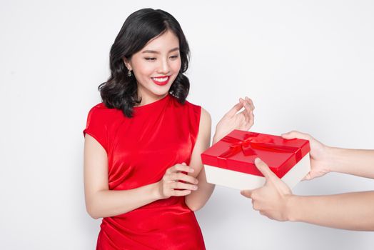 Beautiful happy asian woman in red dress receiving gift box