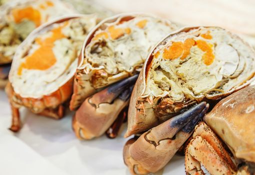 half of fresh crab on ice for sale in a fish market