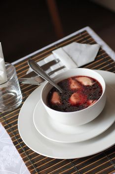 Traditional polish soup red borsch with ear dumplings.