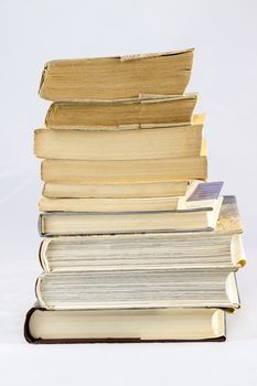 Old dusty book and sheet of paper on white isolated background