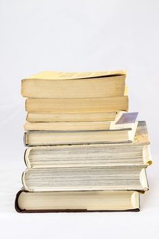 Old dusty book and sheet of paper on white isolated background