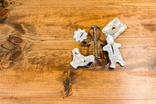 Tin Cookie Cutters Sitting on Wooden Table With Knots