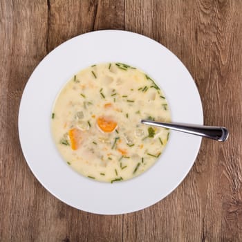 Vegetarian vegetable soup on a wooden table