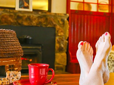 Feet Resting by the Fireplace With a Steaming Hot Cup of Tea