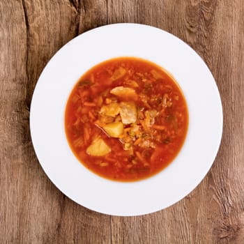 Vegetarian vegetable soup on a wooden table