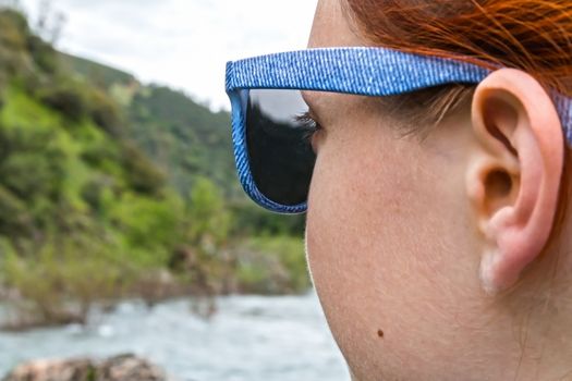 Young Girl With Sunglasses Looking Out Over River