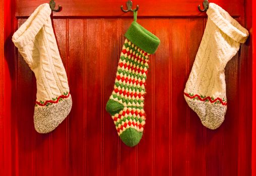 Three Christmas Stocking Hanging on Hooks