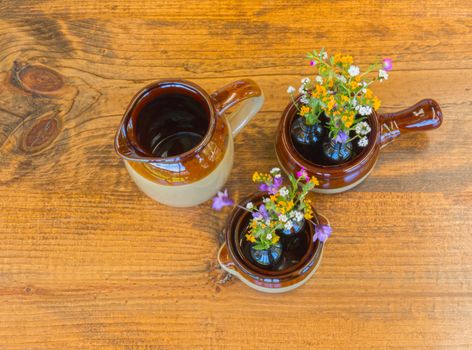 Three Pieces of Crockery With Small Flowers Sitting on Wooden Table