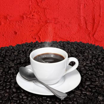 Hot coffee and coffee beans with smoke in a white cup with spoon on red cement wall background.