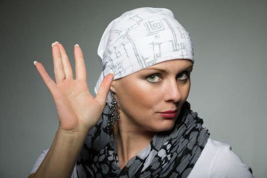 Portrait of beautiful middle age woman patient with cancer wearing headscarf, hope in healing. She lost her hair