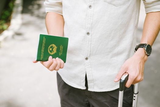 Man hands holding Vietnamese Passport. Ready for traveling.